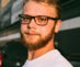 man in white crew neck shirt wearing black framed eyeglasses